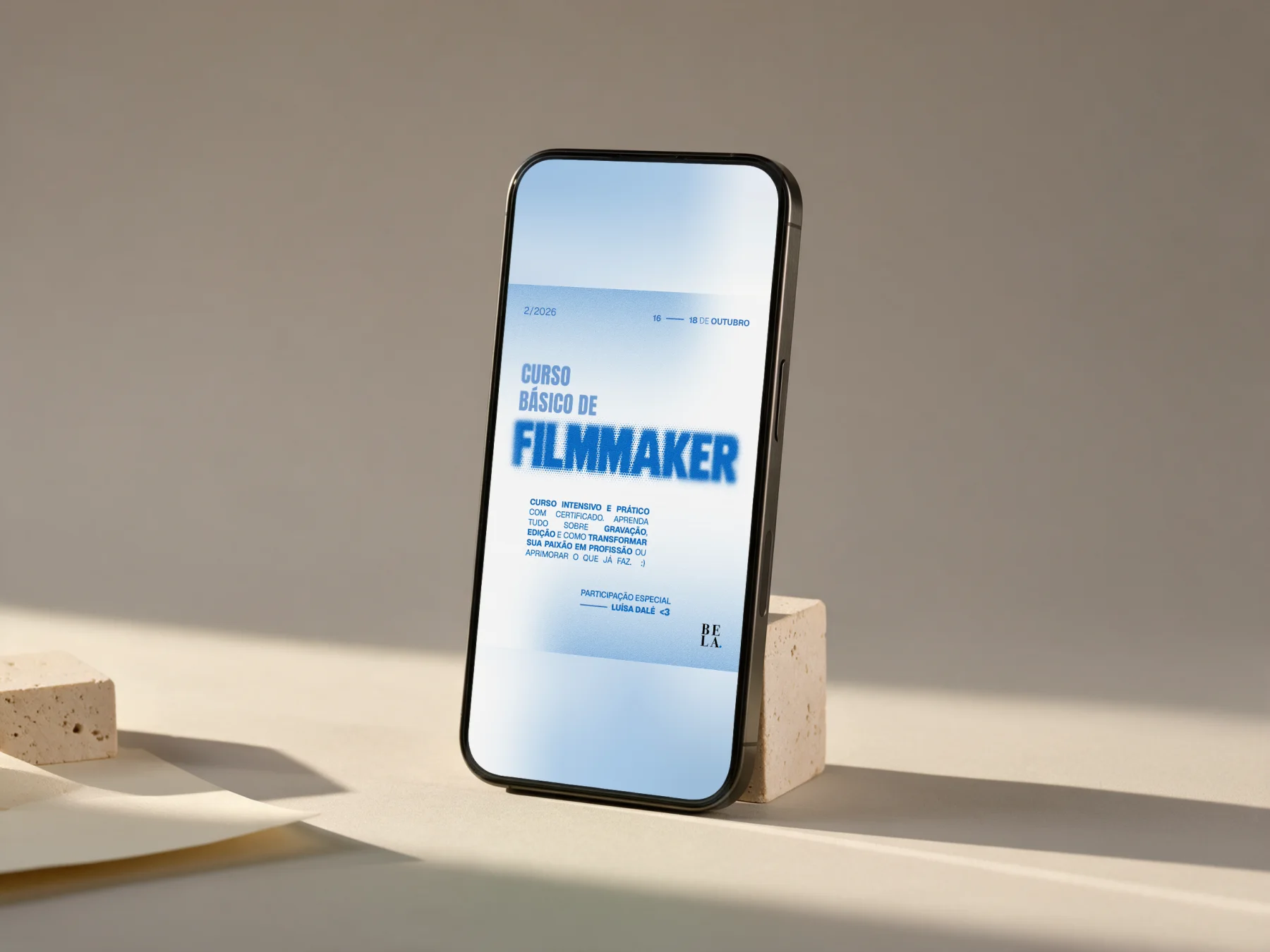 Mockup: phone resting on a stone with the Filmmaker card